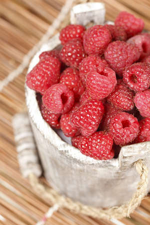 Fresh raspberry in the wooden bucketの写真素材