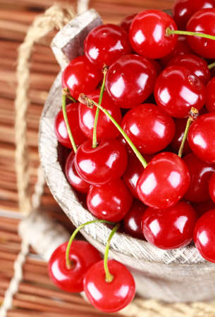 Fresh cherries in a wood bucketの写真素材