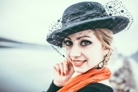 Young pretty sexy lady in black dress outdoor with red lipsの写真素材