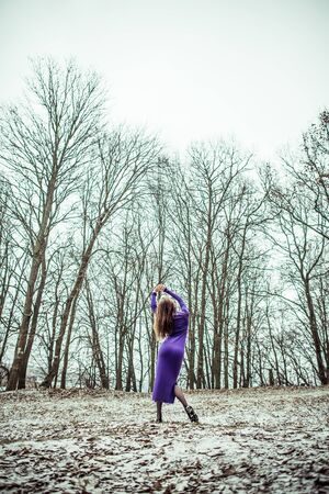 Young pretty sexy girl in dress with forest on backgroundの写真素材