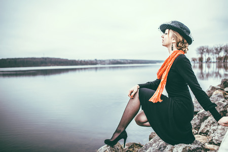 Young pretty sexy lady in black dress outdoor with red lipsの写真素材