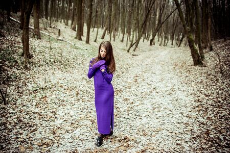 Young pretty girl with forest on backgroundの写真素材