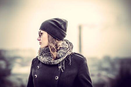 Girl in the sunglasses on the roof of high buildingの写真素材