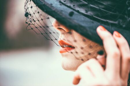 Young pretty sexy lady in black dress outdoor with red lipsの写真素材