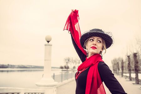 Young pretty sexy lady in black dress outdoor on the bridge with red lipsの写真素材