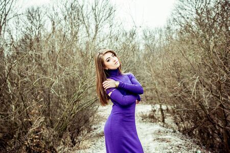 Young pretty sexy girl in dress with forest on backgroundの写真素材