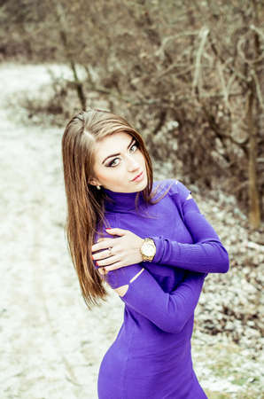 Young pretty sexy girl in dress with forest on backgroundの写真素材
