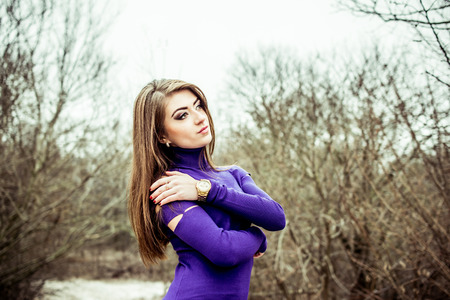 Young pretty sexy girl in dress with forest on backgroundの写真素材