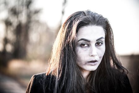 Girl with scary face paintingの写真素材