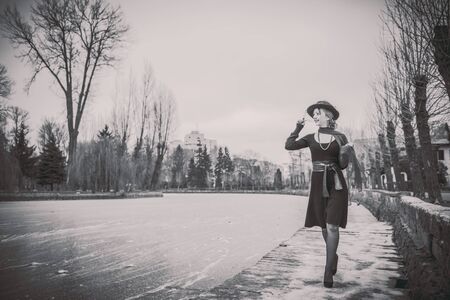 Young pretty sexy lady in black dress outdoor with frozen lake onbackground, black and whiteの写真素材