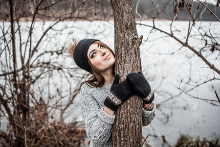 Young pretty girl with forest and lake on backgroundの写真素材