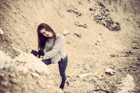 Pretty young woman outdoor in quarry with sand on backgroundの写真素材