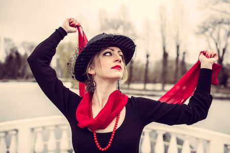 Young pretty sexy lady in black dress outdoor near lake with red lipsの写真素材
