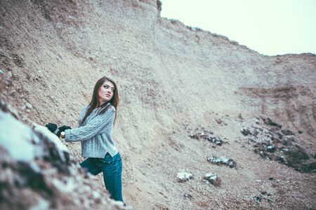 Pretty young woman outdoor in quarry with sand on backgroundの写真素材