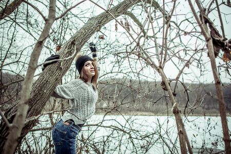Young pretty girl with forest and lake on backgroundの写真素材