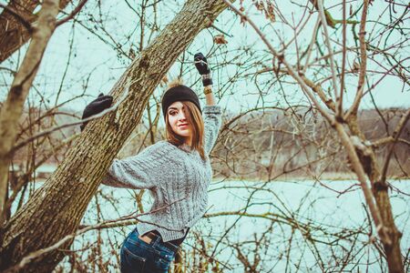 Young pretty girl with forest and lake on backgroundの写真素材