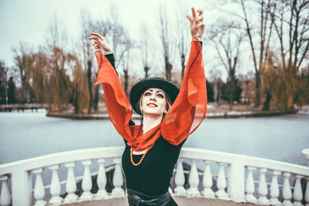 Young pretty sexy lady in black dress outdoor with red lipsの写真素材