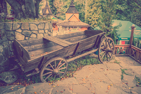Vintage wooden cart in the yard in the autumnの写真素材