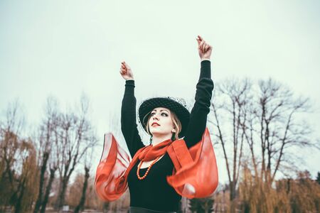 Young pretty sexy lady in black dress outdoor with red lipsの写真素材
