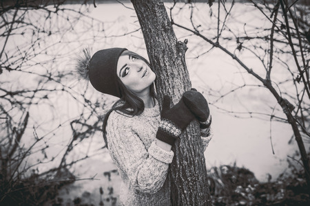 Young pretty girl with forest and lake on backgroundの写真素材