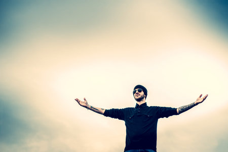 Man with beard on the top of the high building with cityscape on backgroundの写真素材