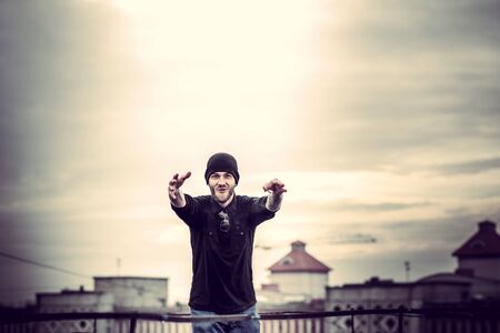 Man with beard on the top of the high building with cityscape on backgroundの写真素材