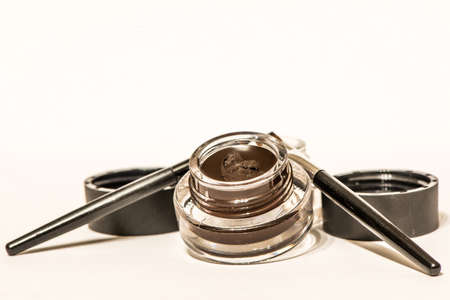 Makeup materials with brushes isolated on whiteの写真素材