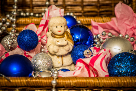 Christmas decoration with balloons in the box on warm background with pretty little angelの写真素材