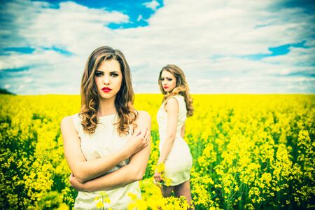 Two pretty girls in the yellow fieldの写真素材