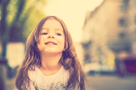 Pretty little girl walking on the city streetの写真素材