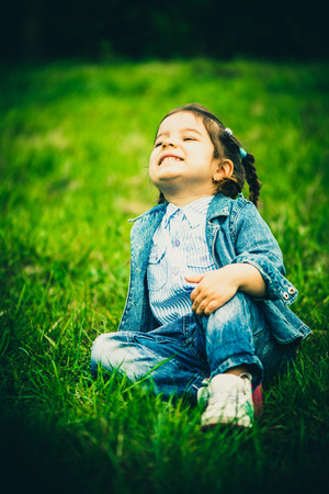 Little happy pretty girl outdoor in the parkの写真素材