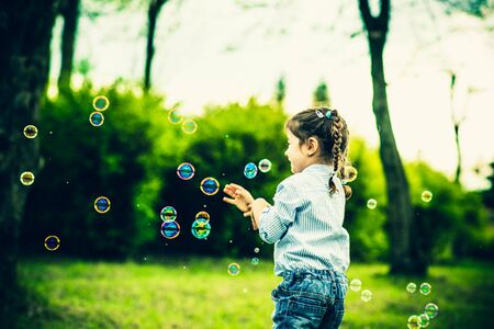 Little happy pretty girl outdoor in the parkの写真素材