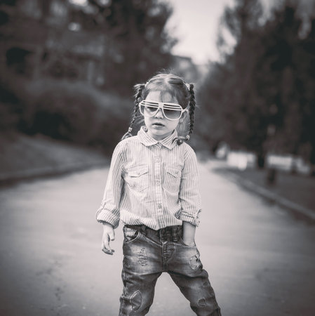 Pretty little girl walking on the city street