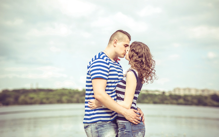 Lovely couple outdoor with lake on backgroundの写真素材