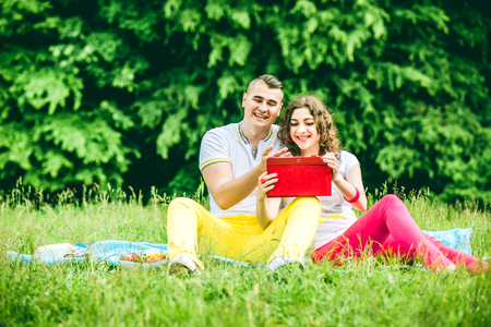Happy couple rest outdoor in the green parkの写真素材