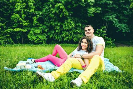Happy couple rest outdoor in the green parkの写真素材