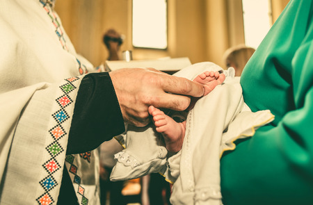 The ceremony of christening the little boy at churchの写真素材
