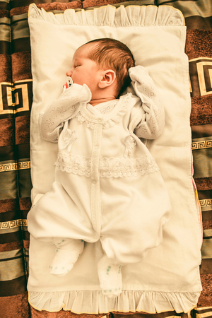 Newborn baby boy sleeping in his bedの写真素材