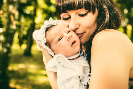 Mother with her newborn baby outdoor in the parkの写真素材