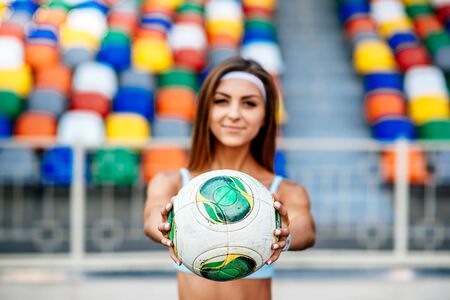Girl workout on stadium in blue shortsの写真素材