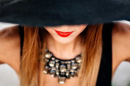 Portrait of pretty girl in black hat outdoorの写真素材