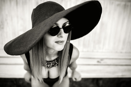 Young pretty sexy girl relaxing outdoor in black swimwearの写真素材