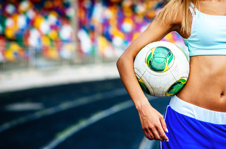 Girl workout on stadium in blue shortsの写真素材