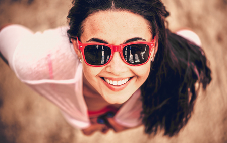 Portrait of pretty girl outdoor looking upの写真素材