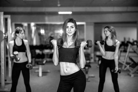 Three pretty girls workout in the gymの写真素材