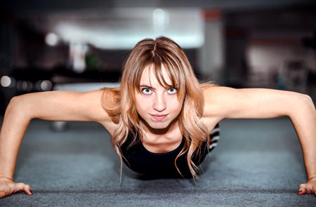 Portrait of young pretty girl training in the gym
