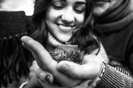 Pretty young couple outdoor holding candleの写真素材