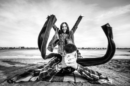 Pretty young couple have fun on the beach