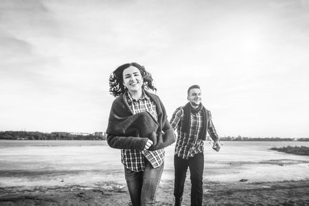 Pretty young couple have fun on the beach