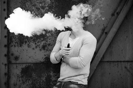Men with beard vaping outdoor in sunglassesの写真素材